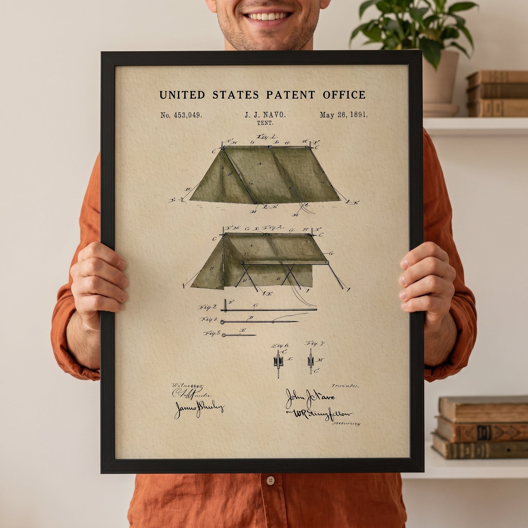 Person holding a large framed 1891 John J. Navo tent patent print to show scale.