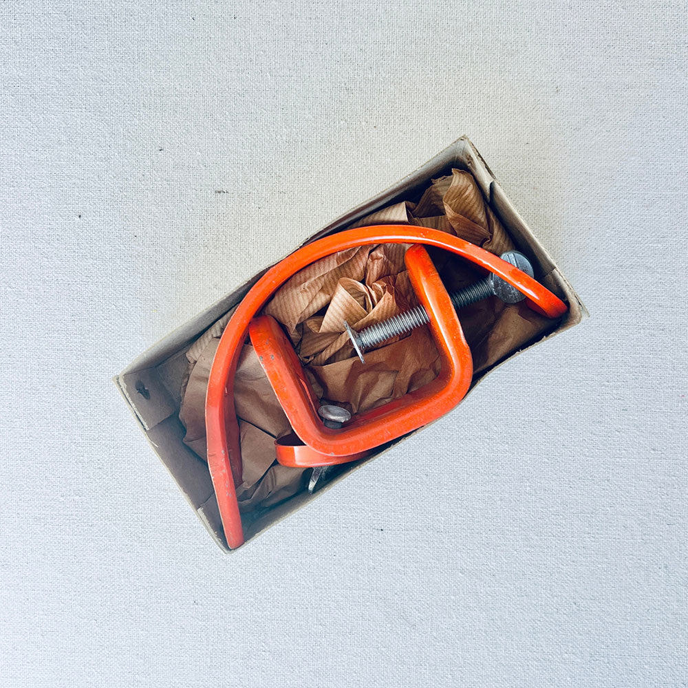 Vintage Sears fishing rod holder with orange metal frame, mounting hardware, and original packing inside the box.