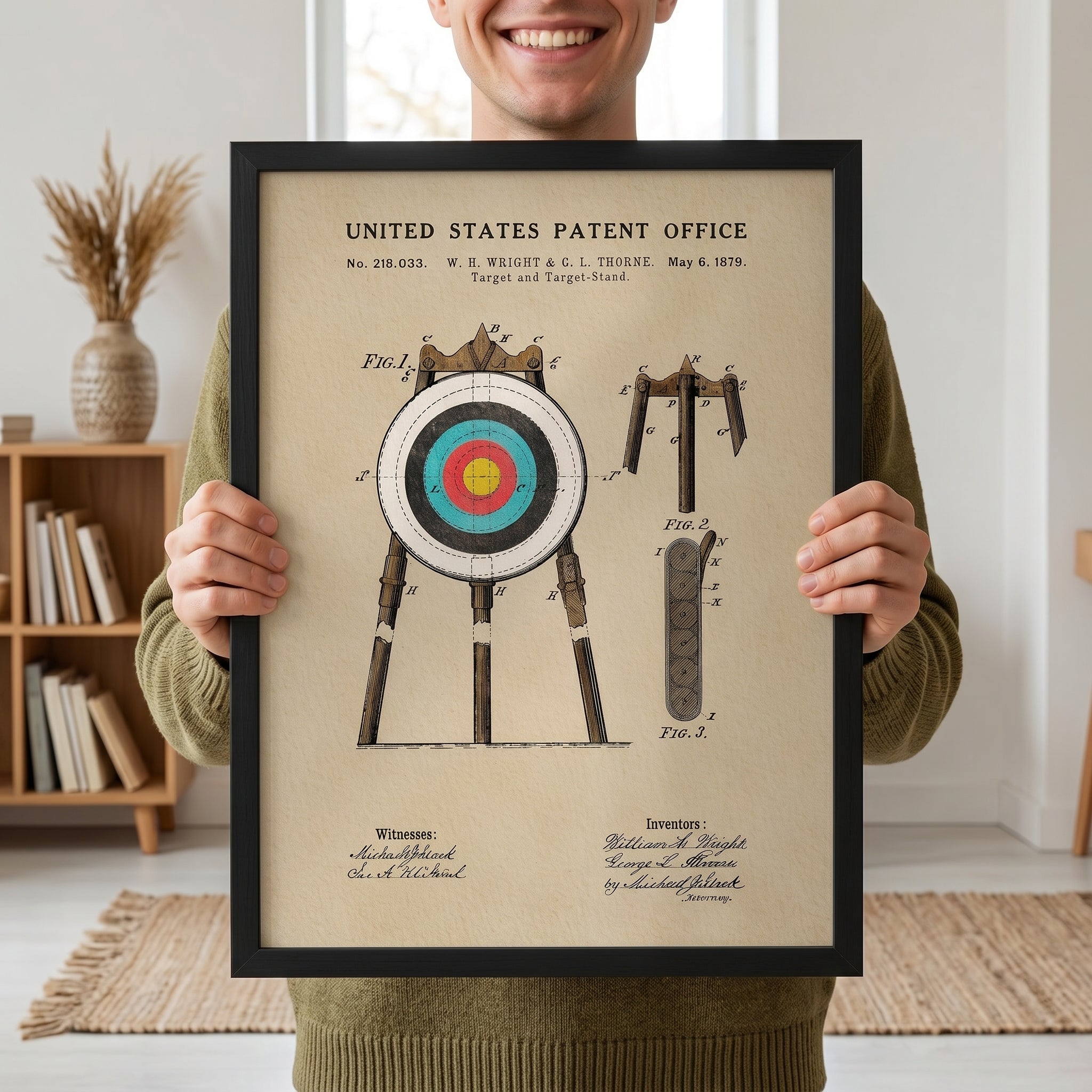 Man holding a framed Archery Target patent print with vintage watercolor artwork