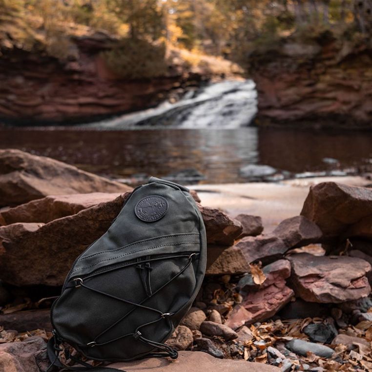 Duluth Pack 16L Canvas Sling Pack beside a river