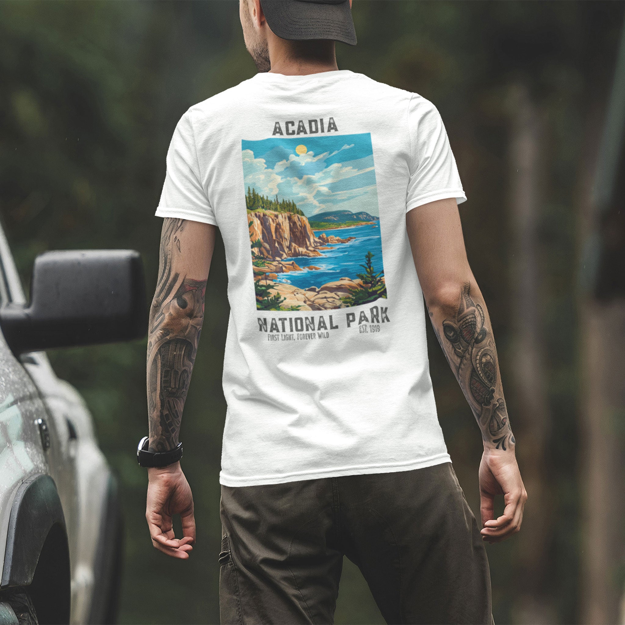 man wearing Acadia National Park t-shirt near truck