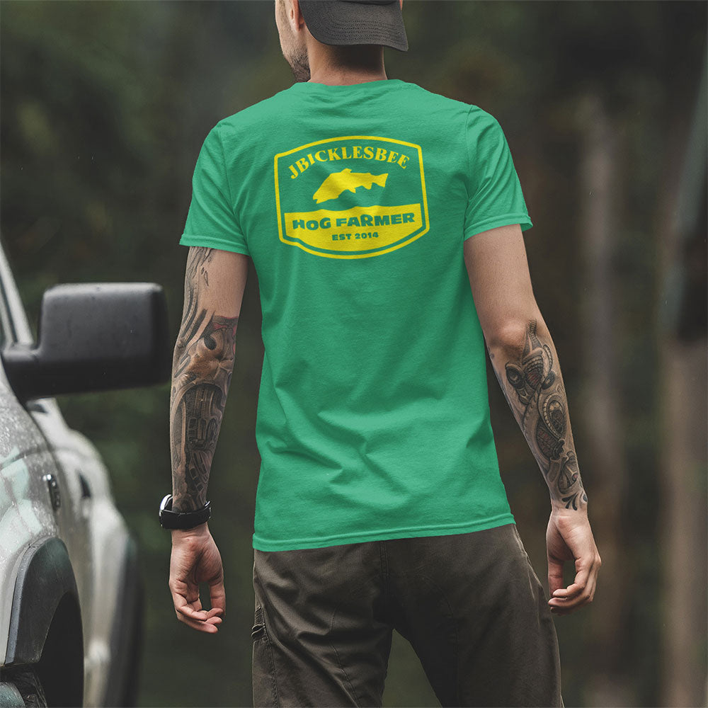man wearing retro hog farmer trout fishing tshirt near truck