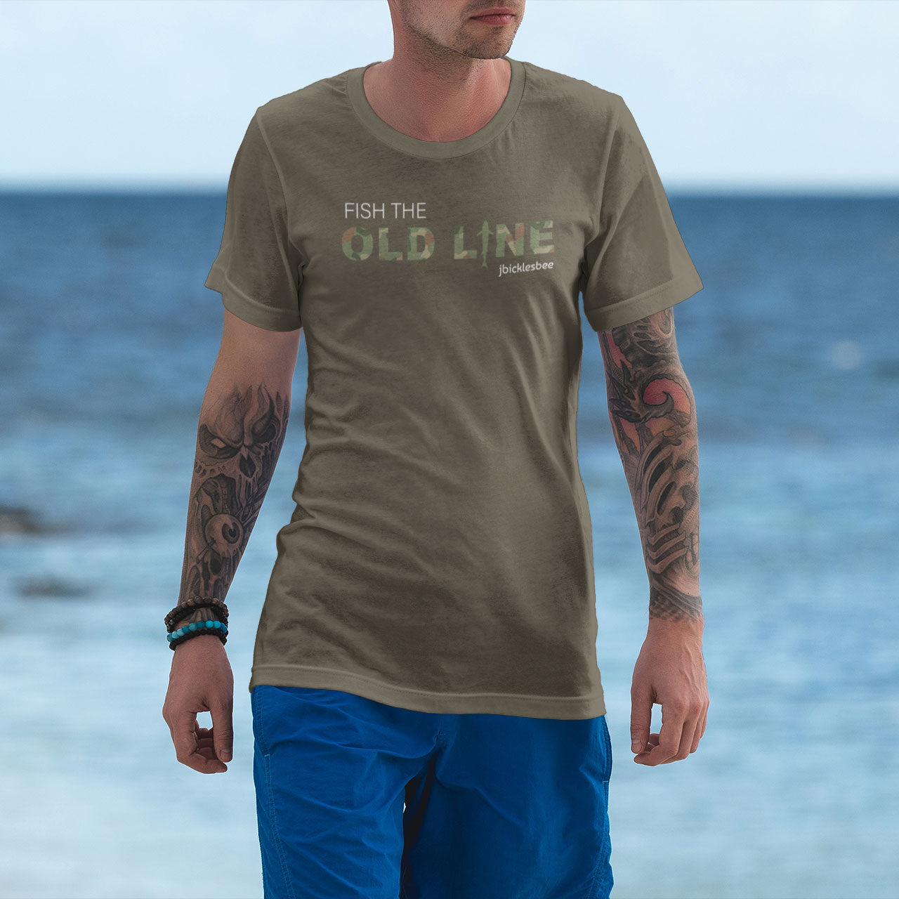 man wearing fish the old line t-shirt army on the beach