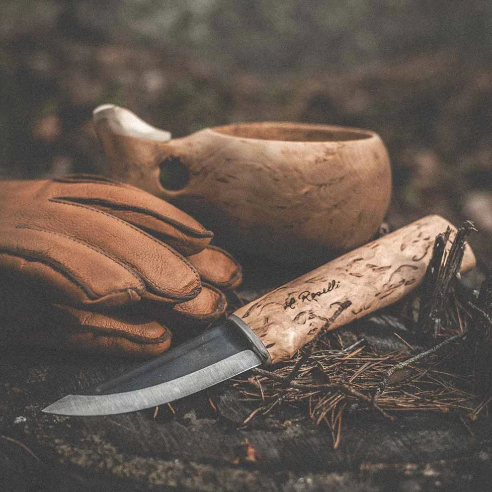 Roselli R100 Hunting Knife being used outdoors for hunting and field processing game