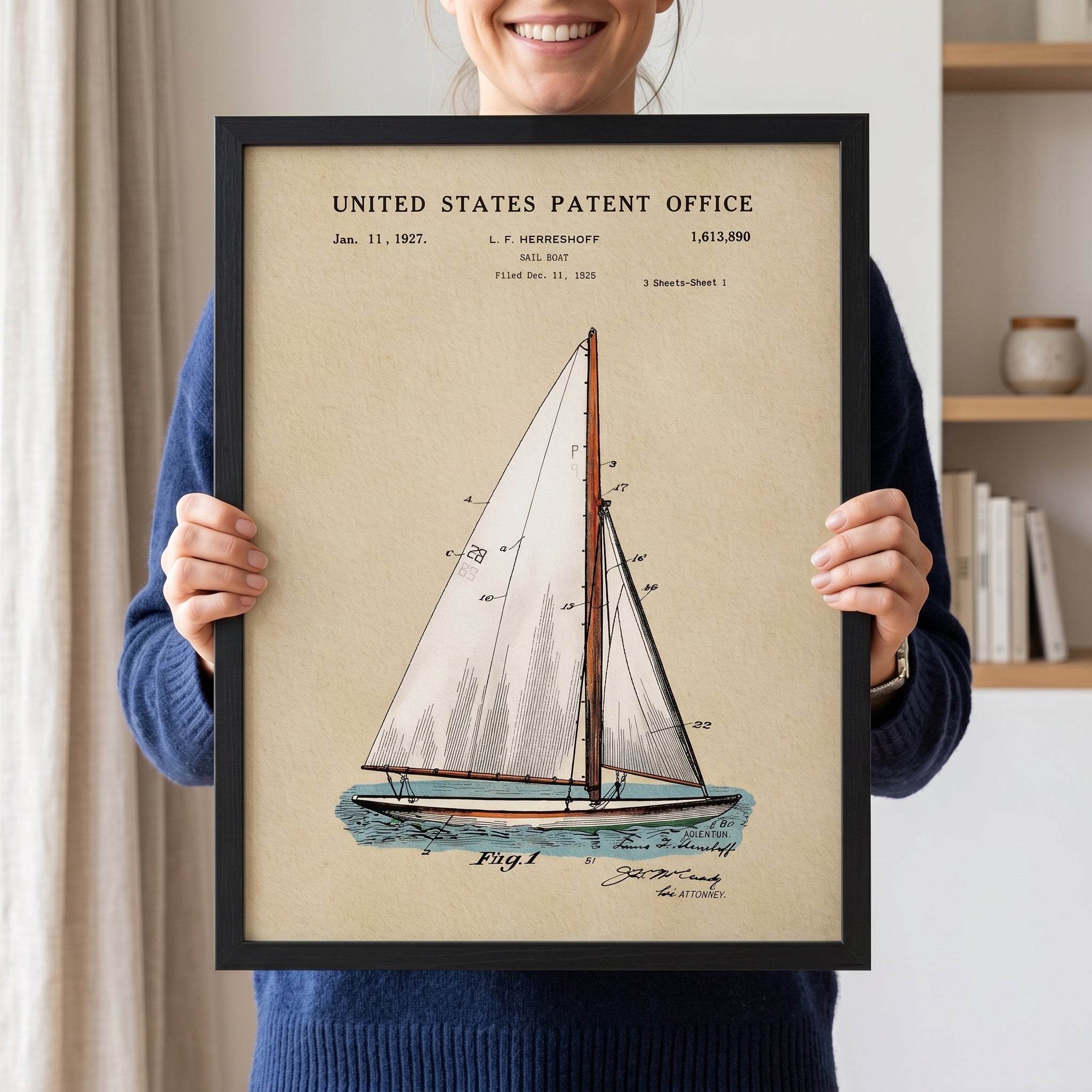 Woman holding a framed Sailboat patent print with vintage watercolor artwork
