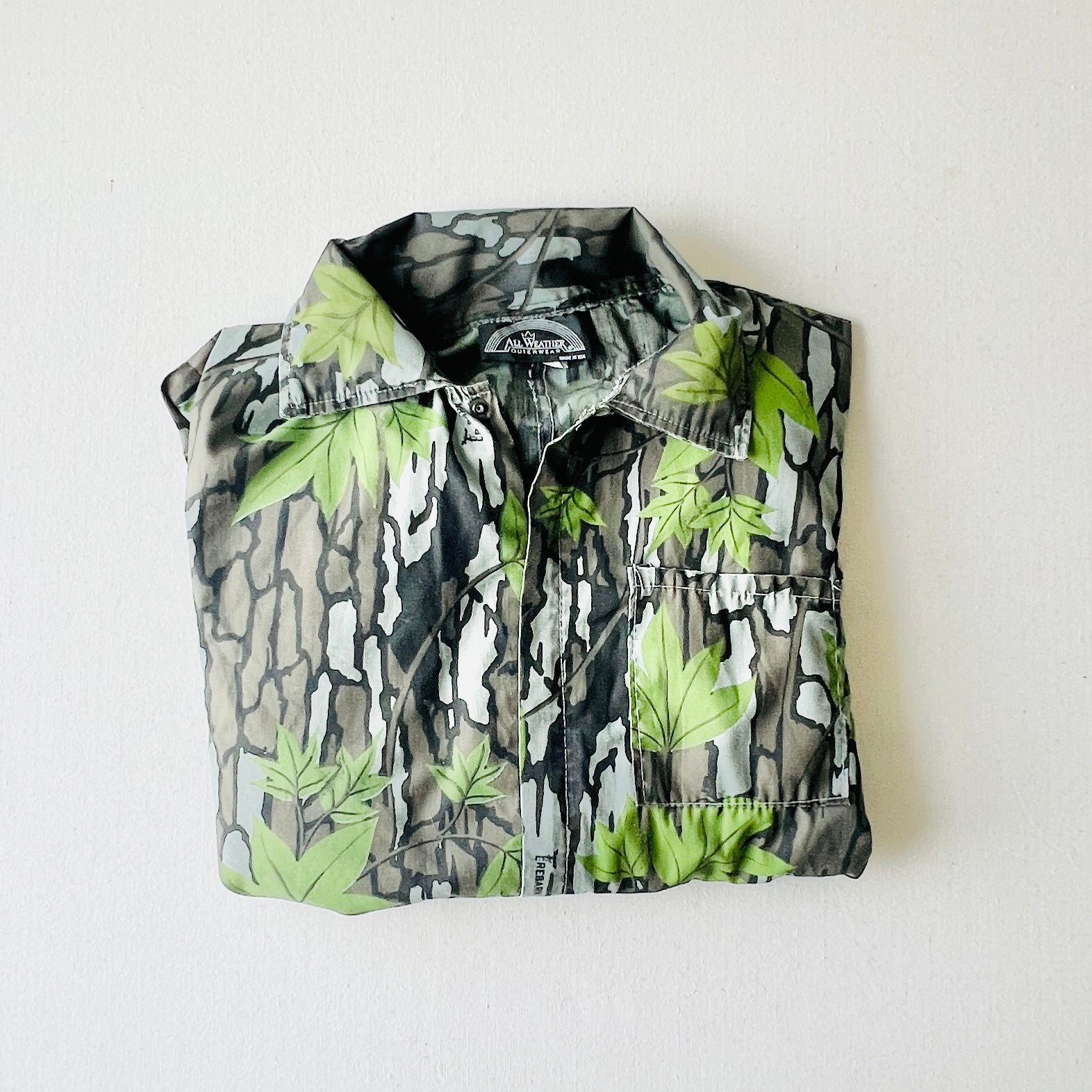 Folded vintage Trebark hunting coveralls showing classic camo pattern