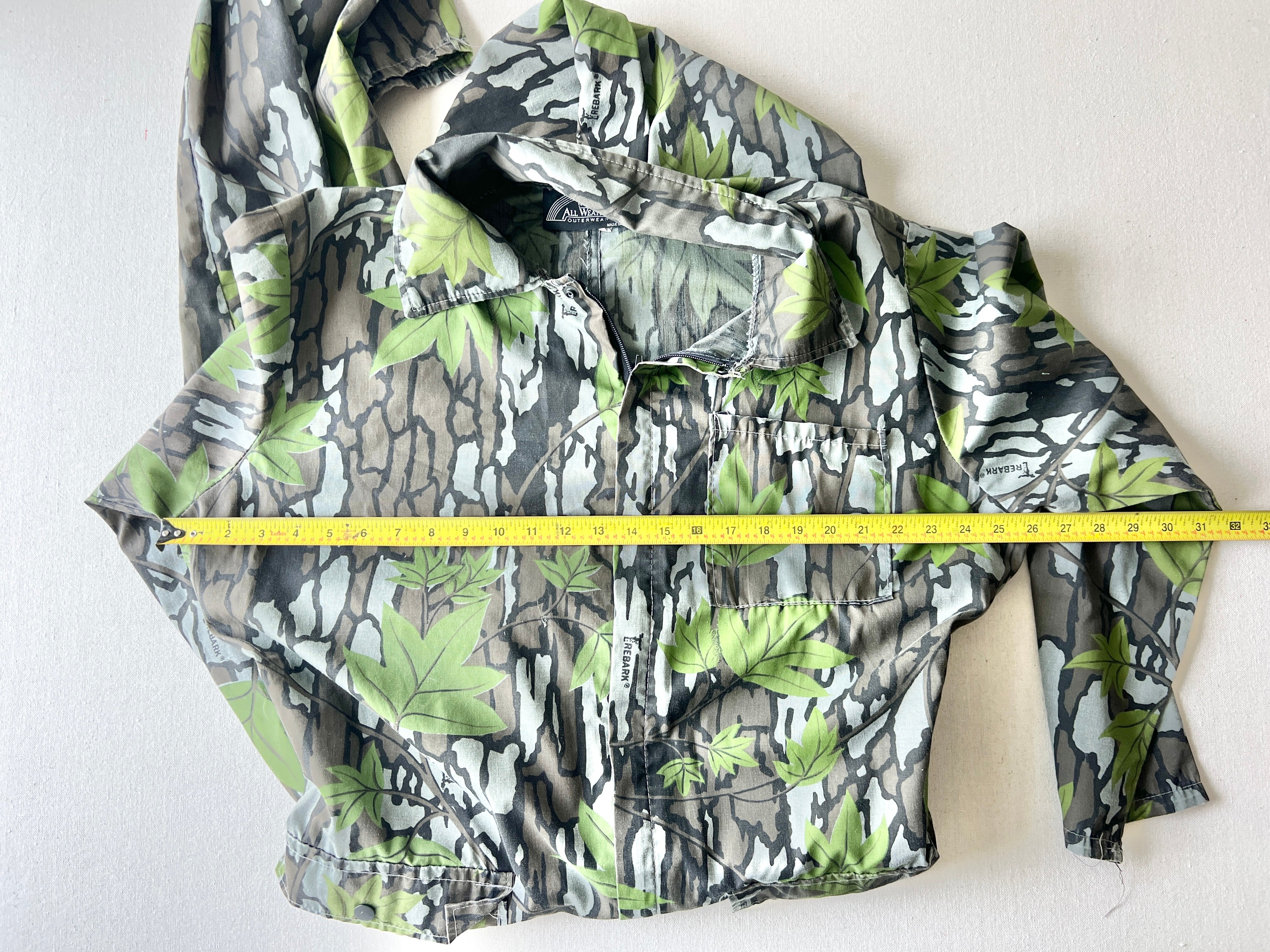 Laid-out Trebark coveralls displaying torso and shoulder width