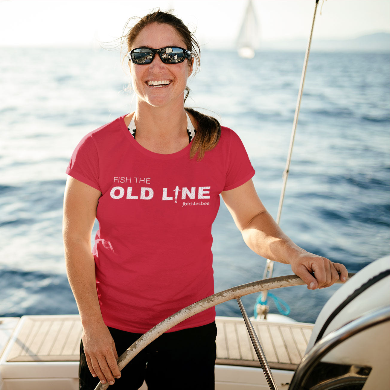woman on sailboat wearing OLD LINE Maryland Fishing T-shirt