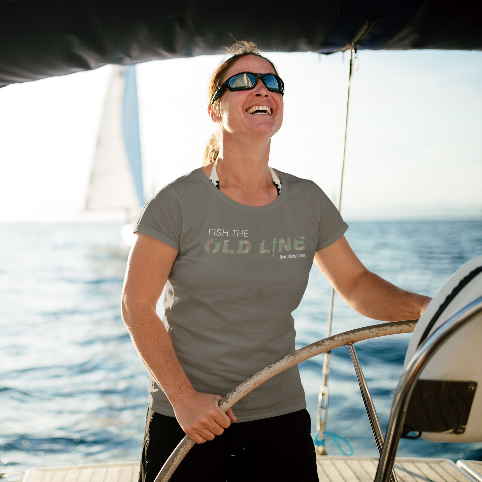 woman on a sailboat wearing old line army t-shirt