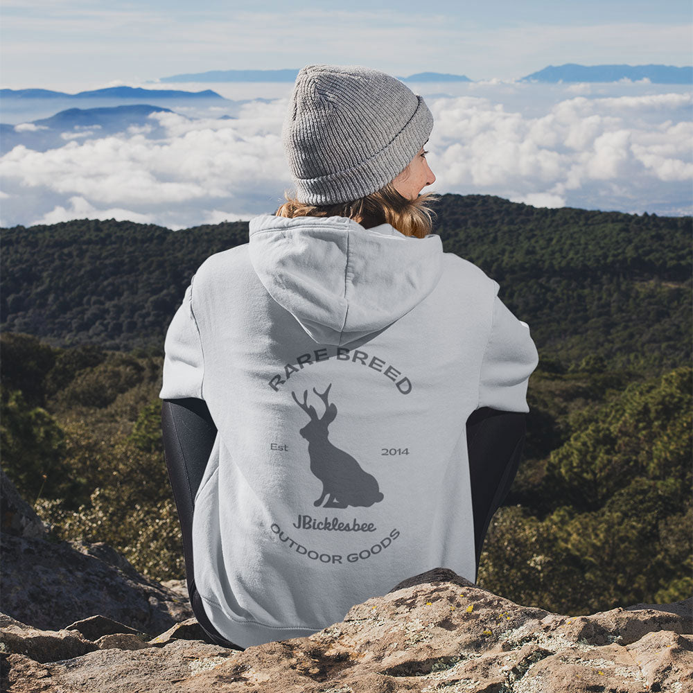 woman wearing man with dog wearing Rare Breed Jackalope Hoodie